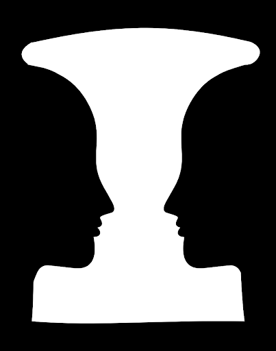 An image of Rubin's Goblet; black and white symmetrical image where one can see either a vase or two faces facing each other.