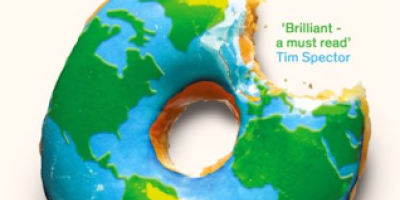 The cover of Ravenous: How to get ourselves and our planet into shape by Henry Dimbleby, featuring a donut colored to look like the world with a bite taken out of Europe.