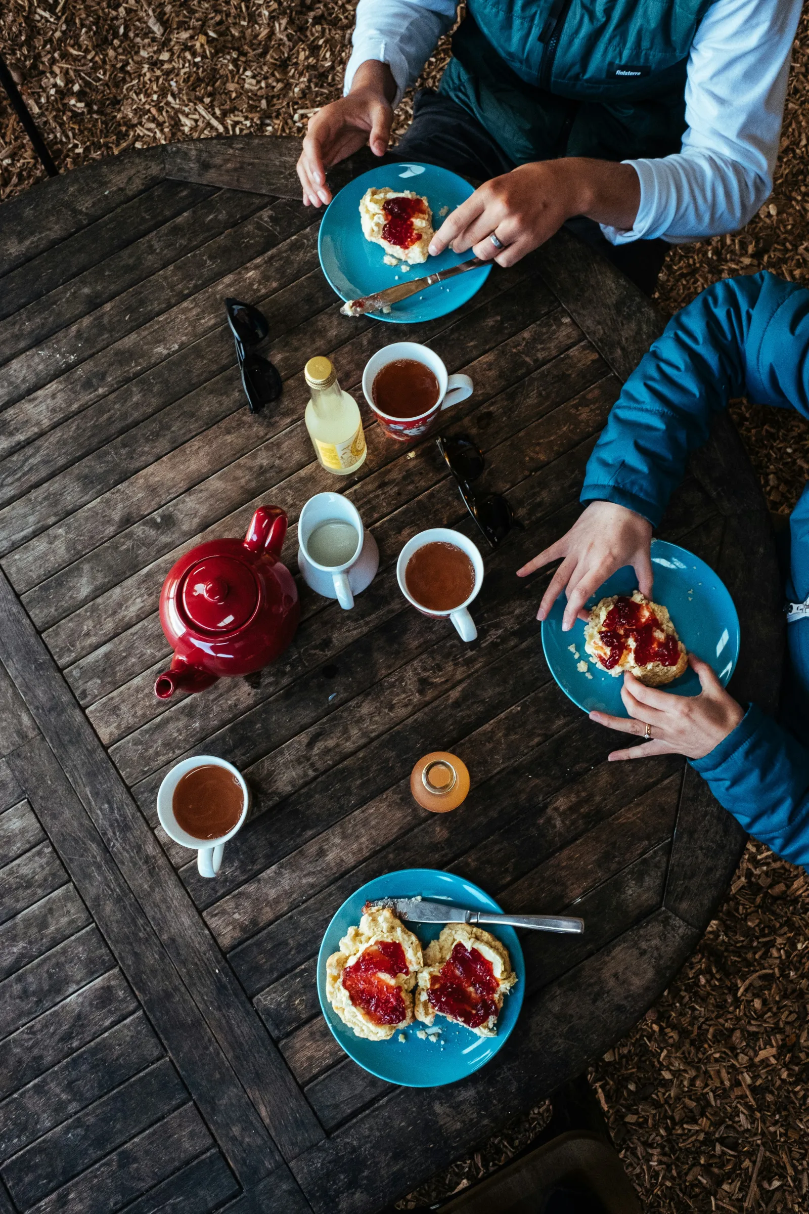 Tea and biscuits on a wooden table. Photo by Robert Bye via Unsplash.