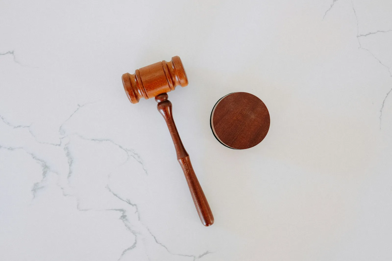 A gavel on a counter. Photo by Tingey Injury Law Firm via Unsplash.