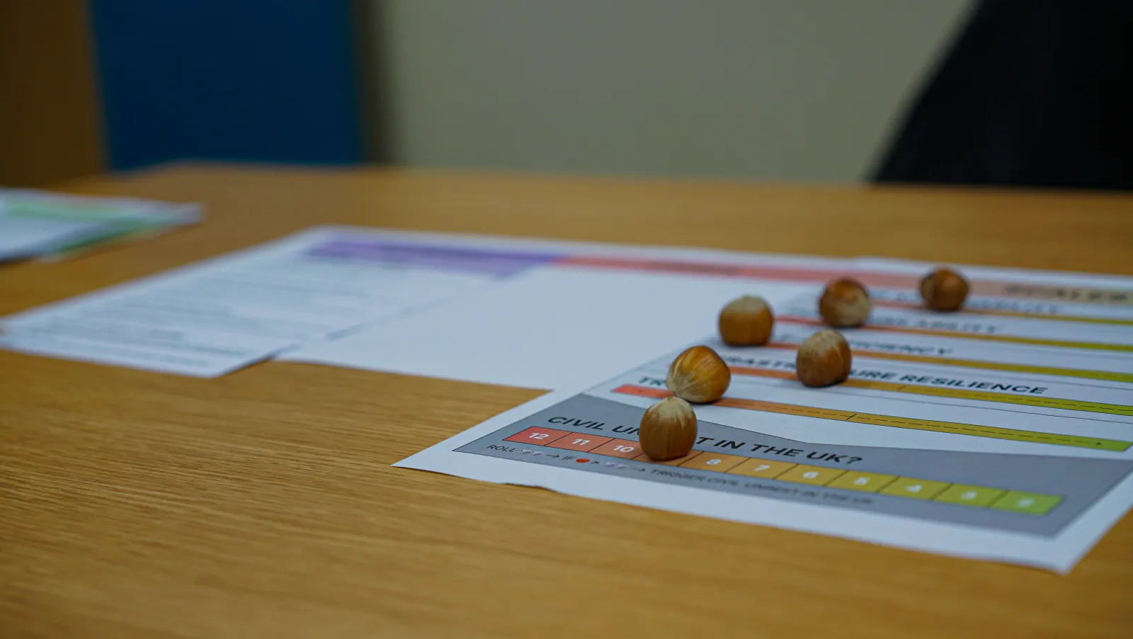 Hazelnuts used as gamepieces on a sheet of paper in the game Barefood. Photo by Jacquelyn Turner.