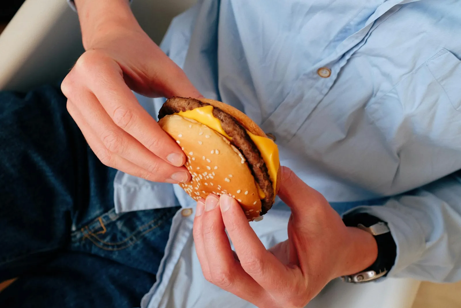 Man eating burger. Credit: ready made via Pexels. 