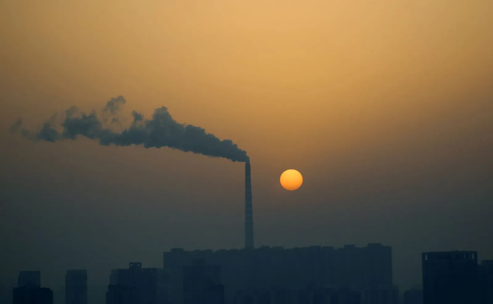 Chimney with smoke and sunset. Credit: Andy Chi via Pexels