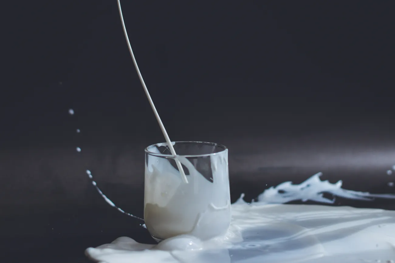 Glass of spilt milk. Photo by Anita Jankovic via Unsplash