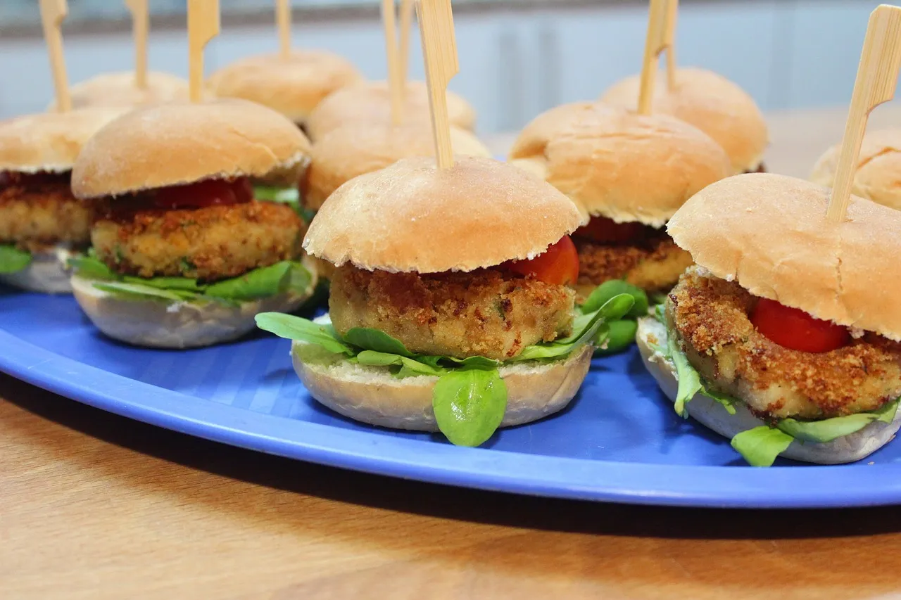 Mini bean burgers on blue platter. Image by Marta Cuesta via Pixabay.