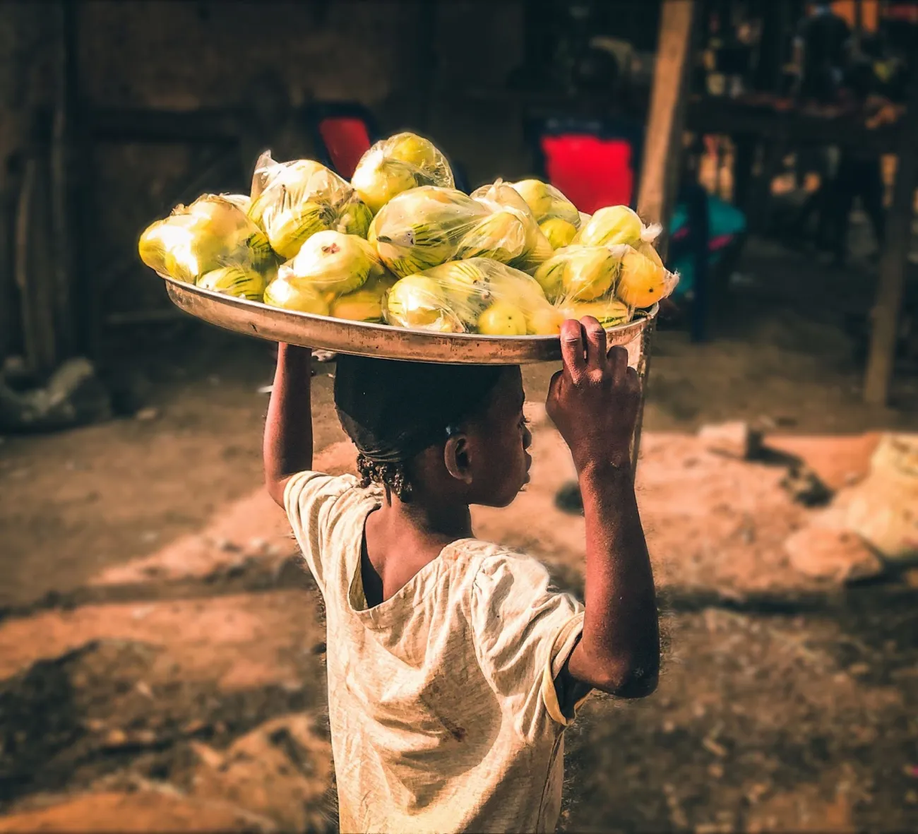 A street hawker selling food in Nassarawa, Nigeria. Photo by victor olamide ajibola via Unsplash