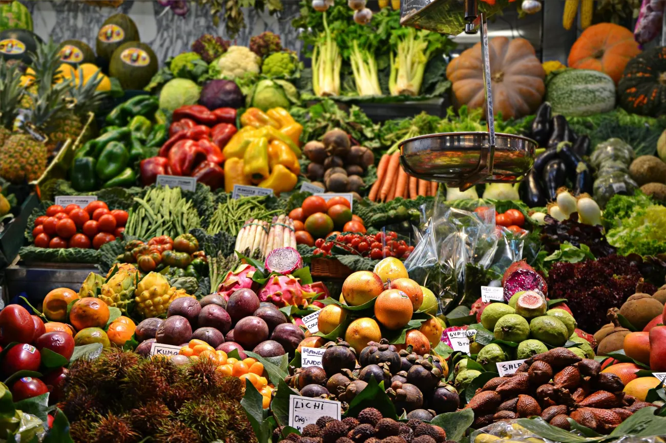 Image of a large vegetable stall in barcelona. Photo by Jacopo Maia via Unsplash