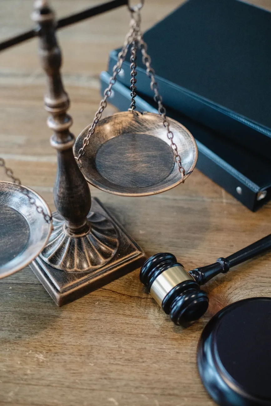 A set of balancing scales and a judges gavel. Photo by Sora Shimazaki via Pexels.