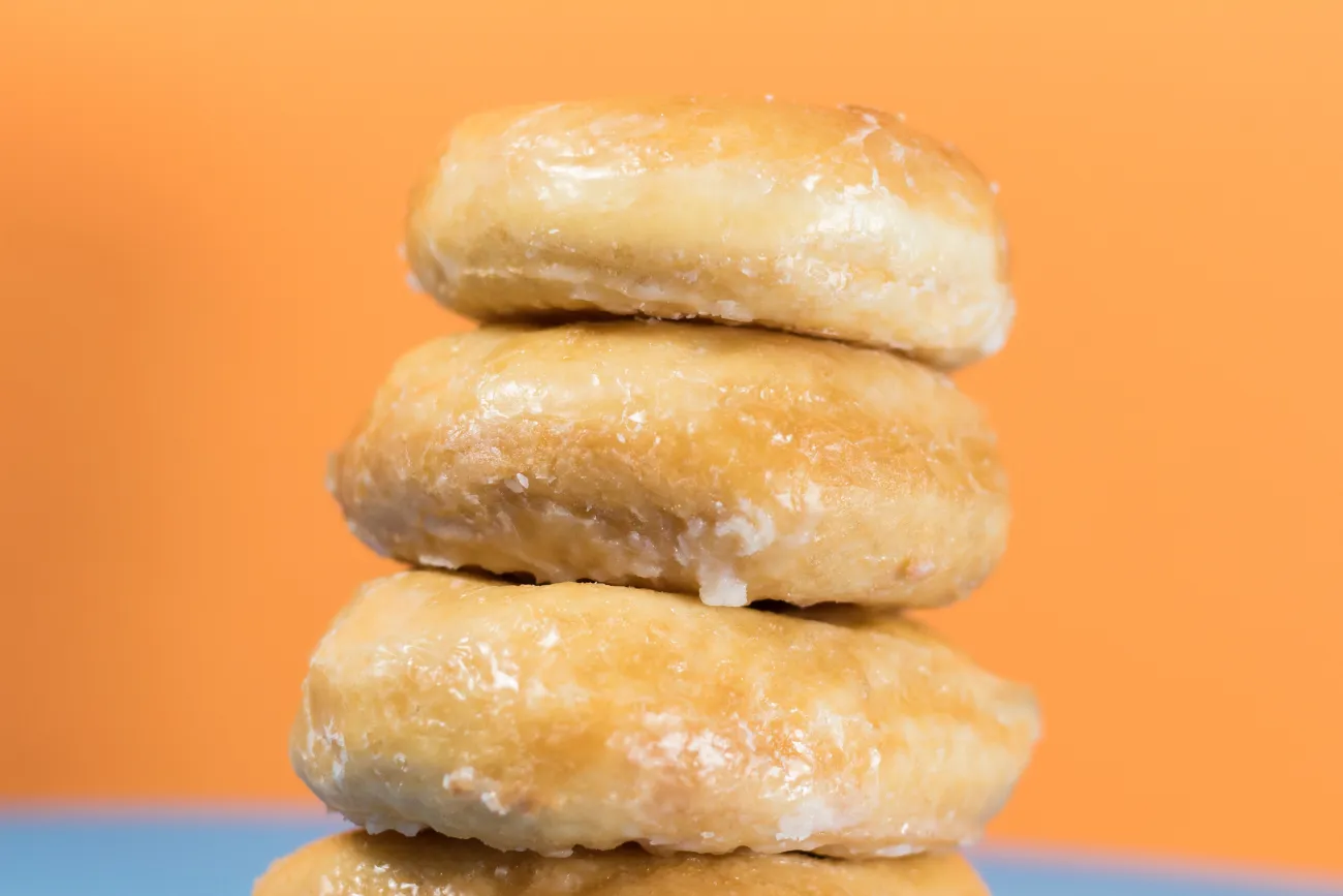 A pile of sugar coated doughnuts. Photo by Kyle Brinker via Unsplash.
