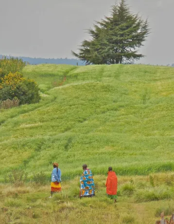 Front cover of Landesa report of three people walking in an agricultural field. Title: Links between Women’s Land Tenure Security and Climate Action: An Evidence Brief