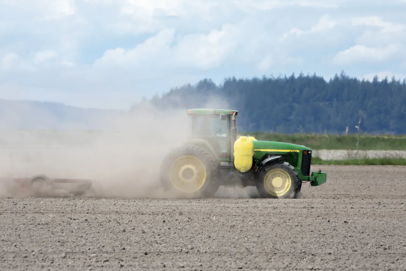 Image of a tractor ploughing a barren field. Photo by Chris LeBoutillier via Pixabay.