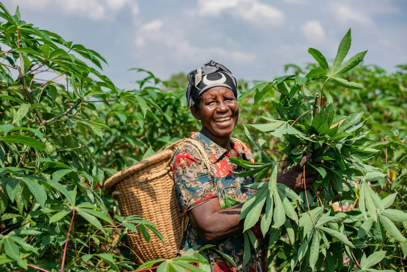 Woman smiling in an agricultural field. Photo by Safari Consoler via Pexels