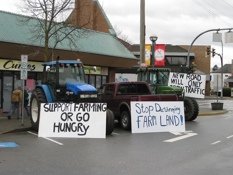 Image: Tractors with protest signs in the street. Photo by stopthepave via flickr