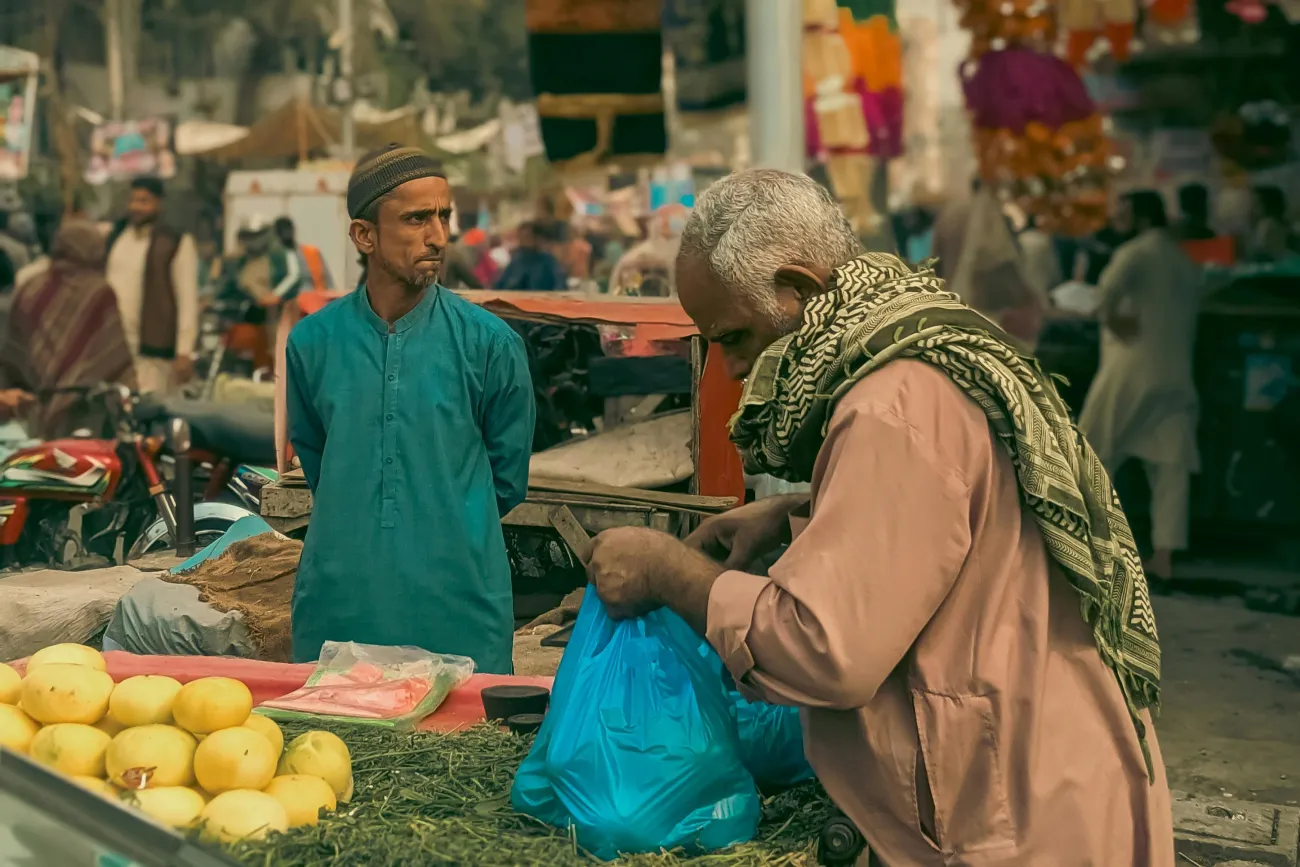Man purchasing food at market. Photo by Qamar Rehman via Pexels
