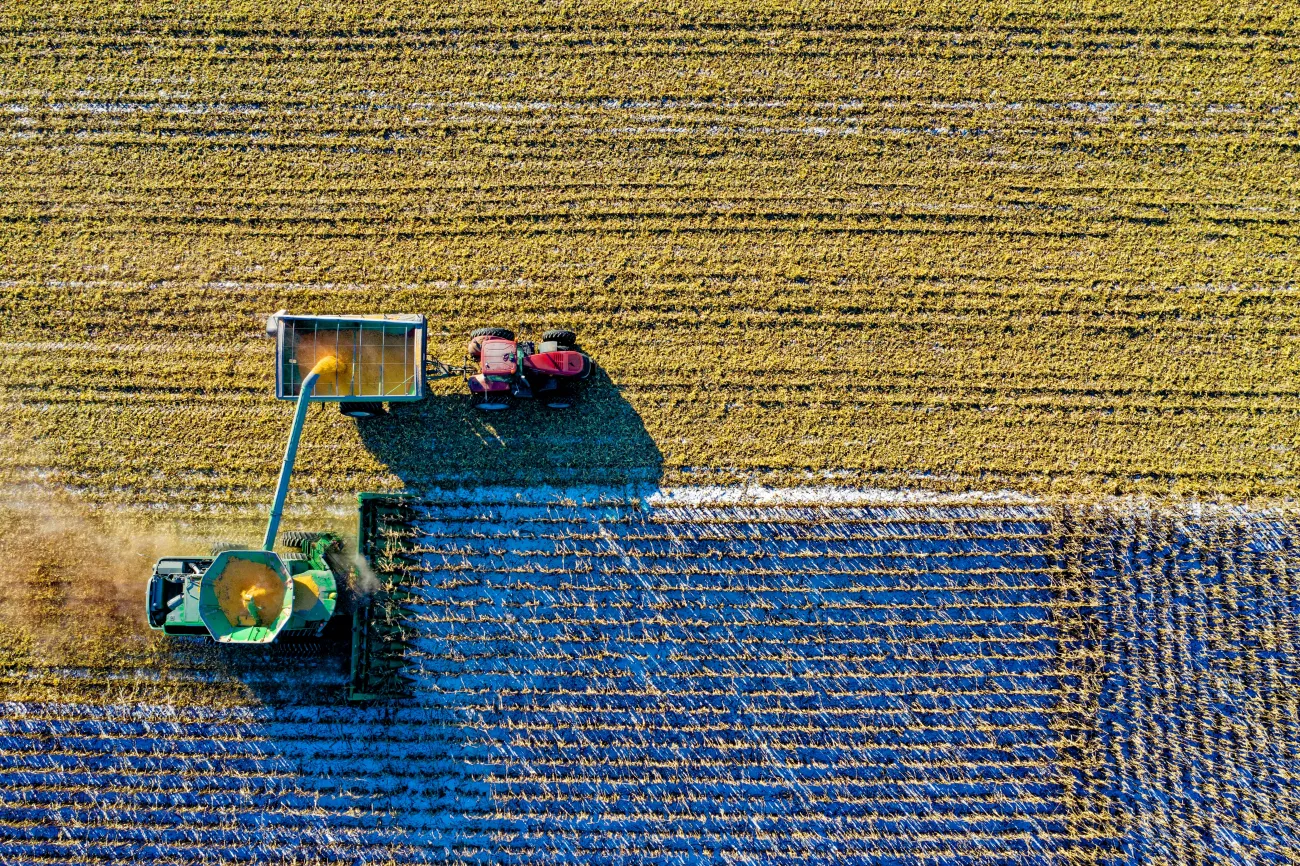 Bird's eye angle of combine harvester unloading into tractor and trailer. Credit: Tom Fisk