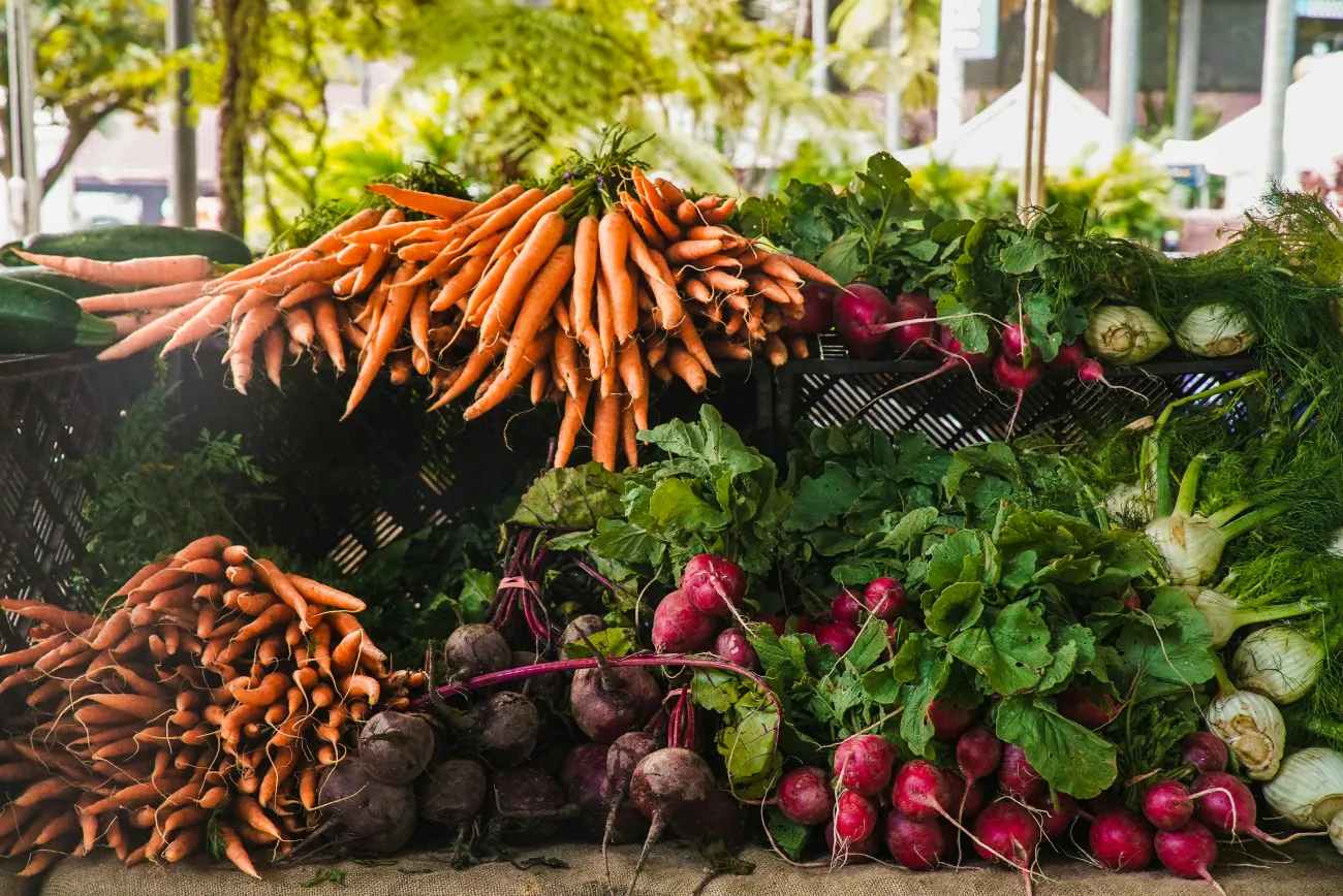 Picture of vegetables stacked at a market