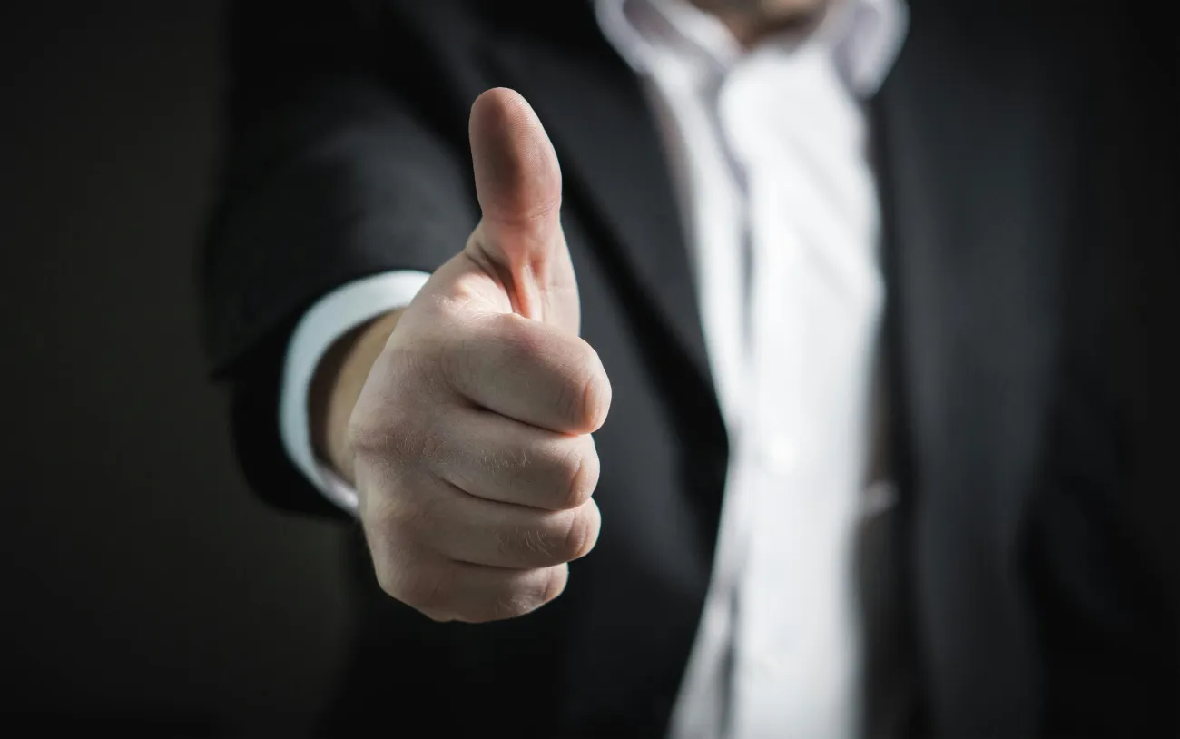 Photo of someone in a suit with thumbs up. Credit: Pixabay via Pexels