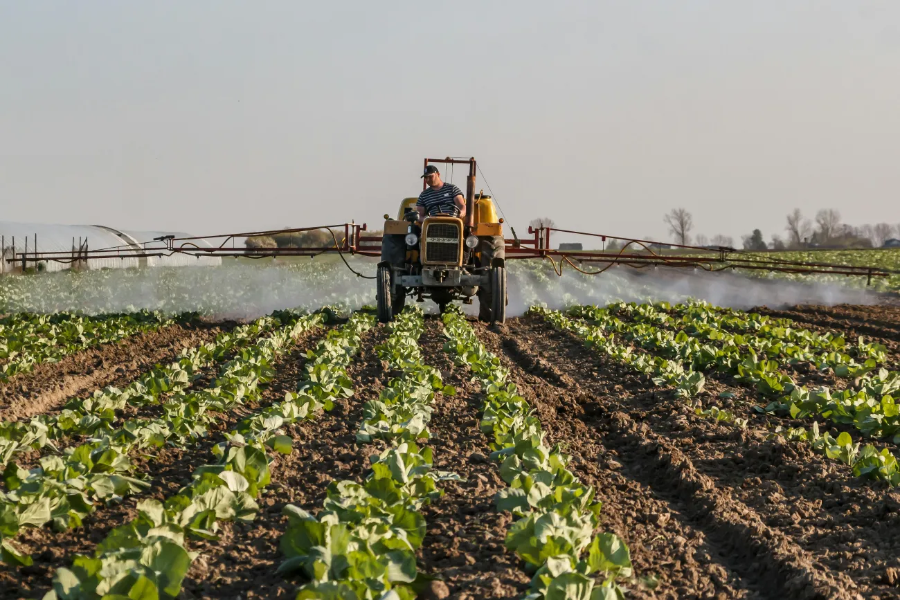 Photo of tractor with sprayer in field. Credit Stitch via Pexels