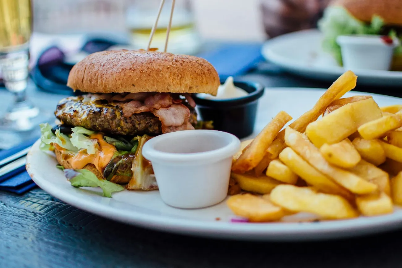 Plate with burger and chips. Credit: Robin Stickel via Pexels
