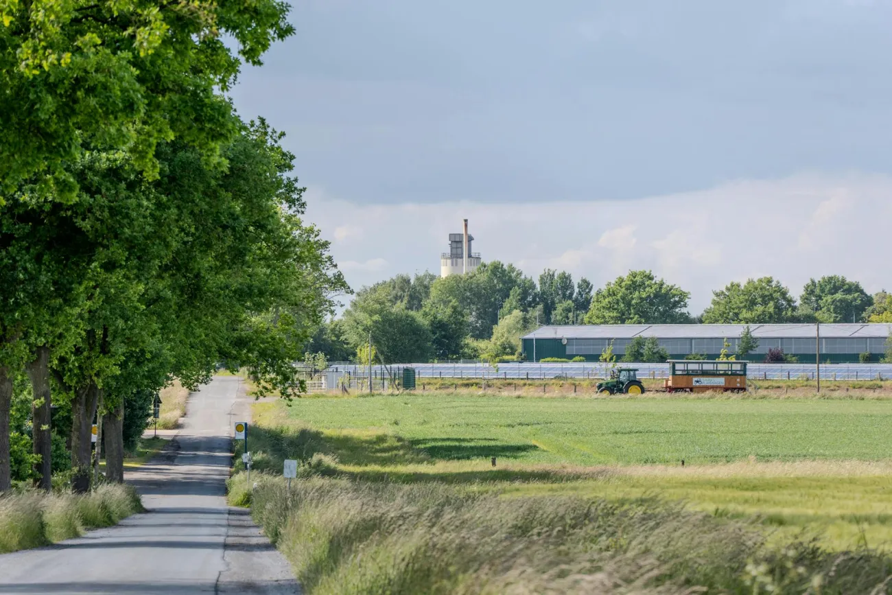 Photo of field with factory in background. Credit: Sergej Karpow via Pexels