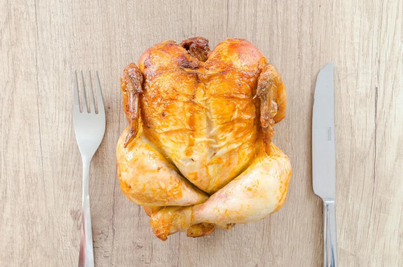 Whole Roast Chicken in between knife and fork. Credit: Lukas via Pexels