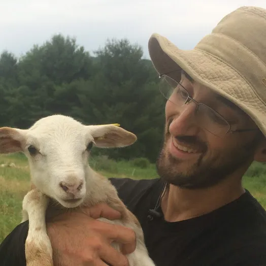 Matthew Kessler holding a lamb 