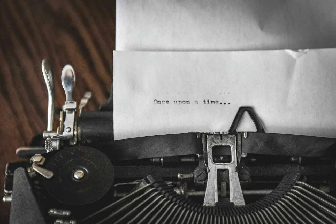 A typewriter with the phrase "Once upon a time . . ." typed on a blank piece of paper. Photo by Dani Adkins.