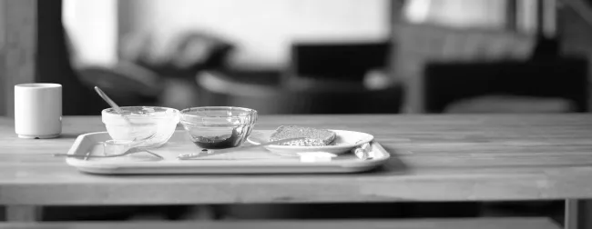 An empty plate post-meal on a wood table