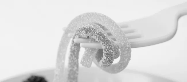A fork with sugary looking sweets on it.