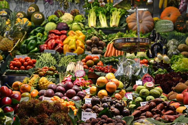 Image of a large vegetable stall in barcelona. Photo by Jacopo Maia via Unsplash