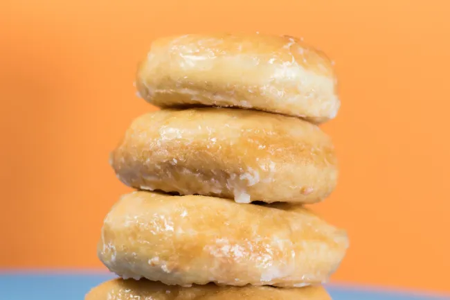 A pile of sugar coated doughnuts. Photo by Kyle Brinker via Unsplash.