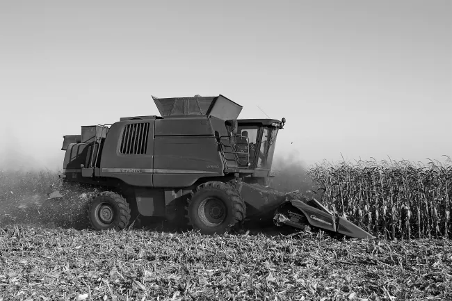 Photo of a combine harvester in black and white. Credit Alex Rusin via pexels