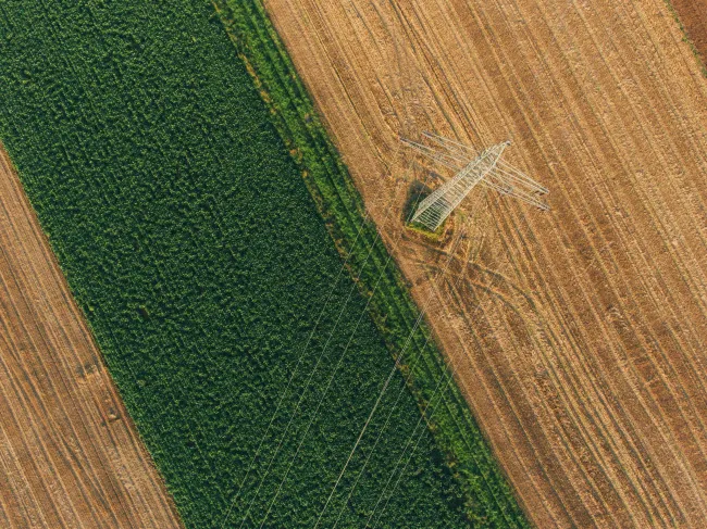 birds eye view of field and pylon, Max Bottinger via Unsplash