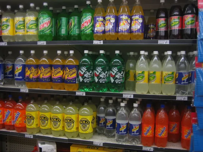 Image: SMC at English Wikipedia, Soft drinks on shelves in a Woolworths supermarket, Wikimedia Commons, Public domain