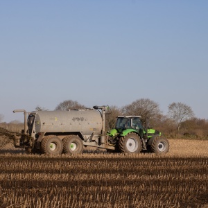 Tractor spreading fertiliser on field. Photo by Mirko Fabian via Pexels.