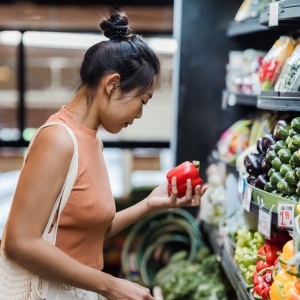  Image of a woman looking at vegetables in a supermarket aisle. Photo by Greta Hoffman via Pexels
