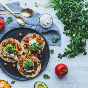 Image of three vegan tacos and other fresh ingredients. Photo by shanriley via Unsplash 