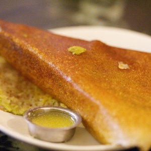 Image: Charles Haynes, Dosa (rice pancake) with a cup of ghee (clarified butter) at Mavalli Tiffin Room in Bangalore, Wikimedia Commons, Creative Commons Attribution-Share Alike 2.0 Generic